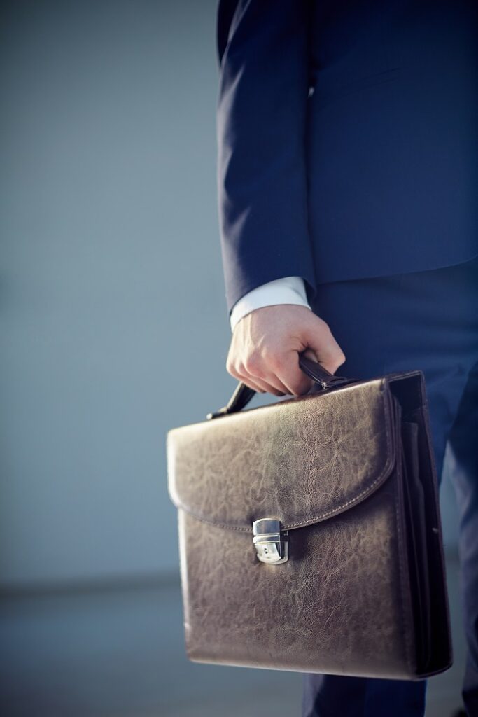 businessperson carrying a leather briefcase